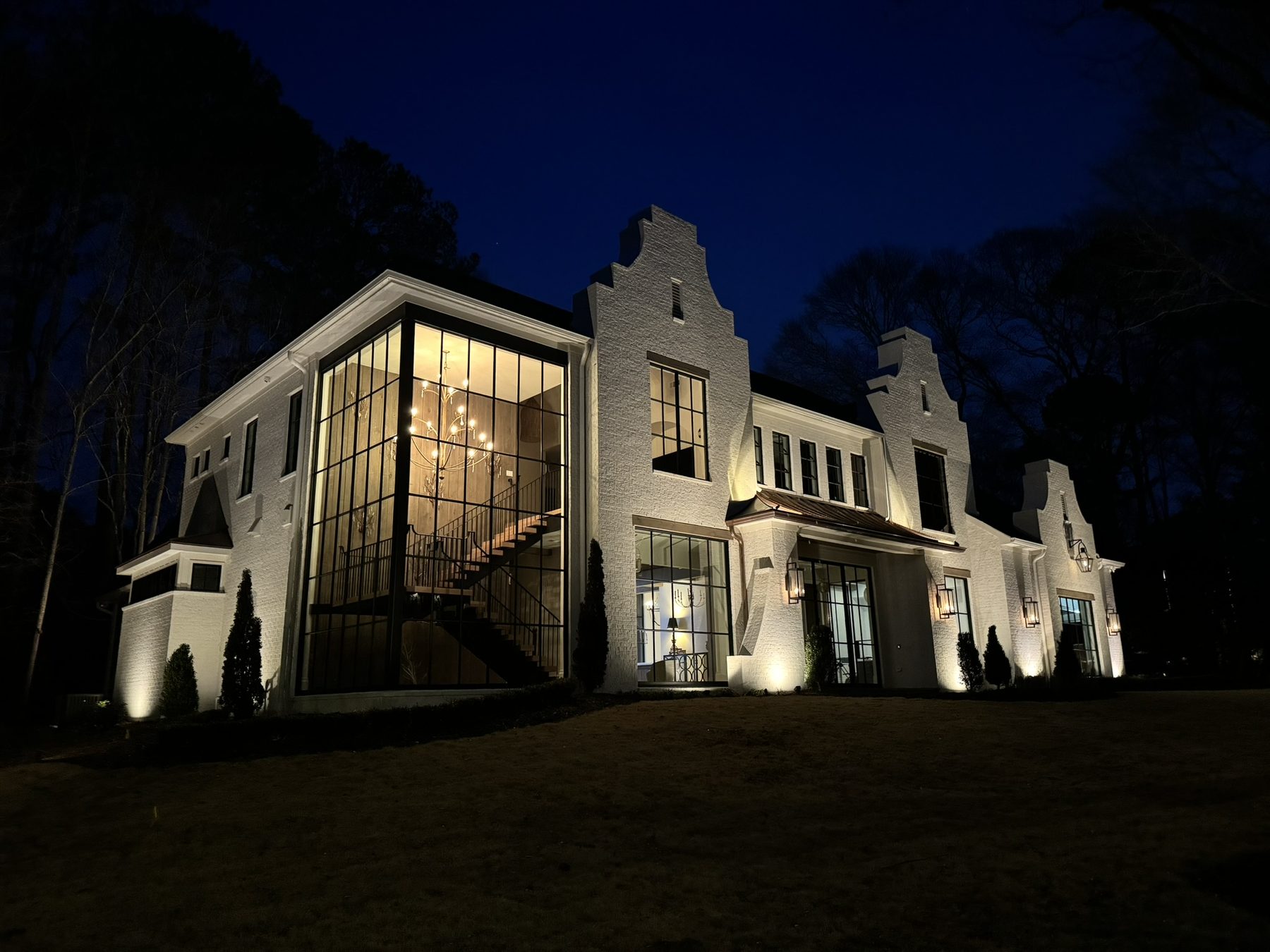 Custom home exterior lit at night