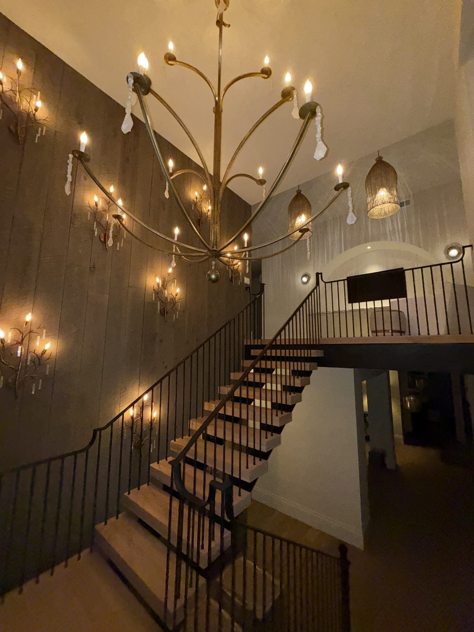 Custom staircase with iron railing and chandelier