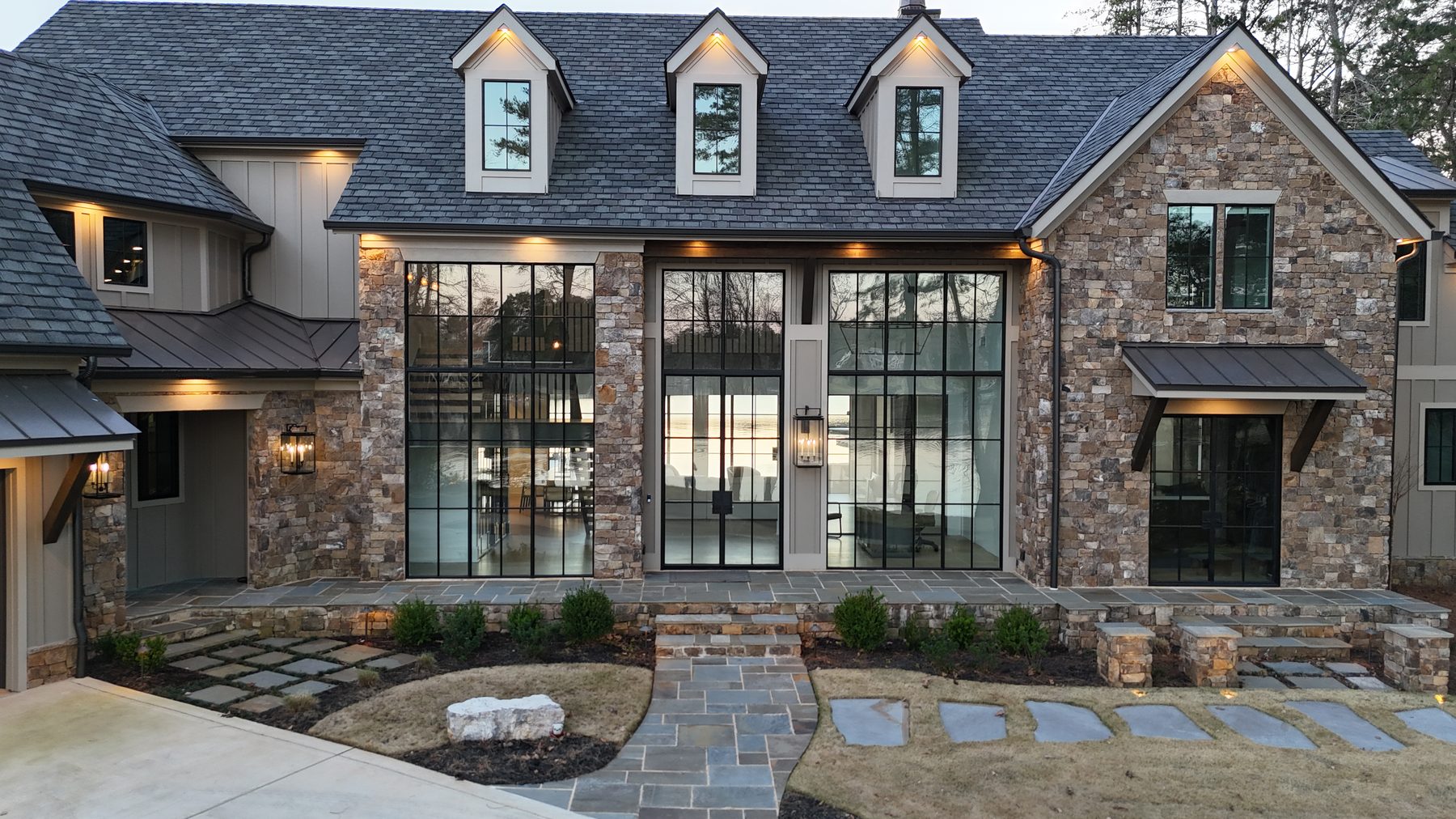 Stone and copper home exterior at dusk